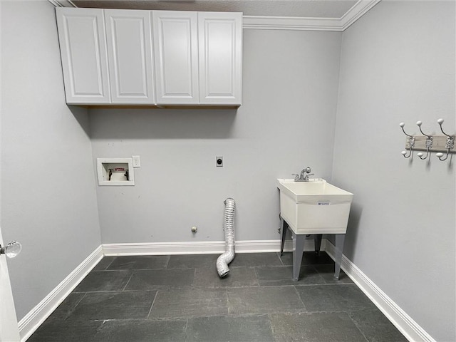 clothes washing area featuring washer hookup, hookup for a gas dryer, cabinet space, electric dryer hookup, and baseboards