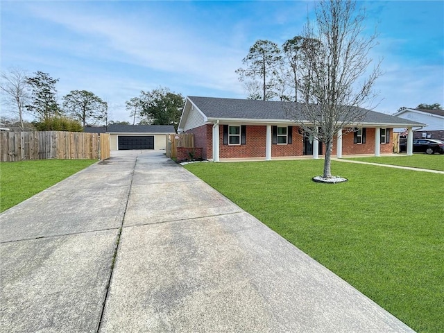 ranch-style home featuring brick siding, a front yard, fence, a garage, and an outdoor structure