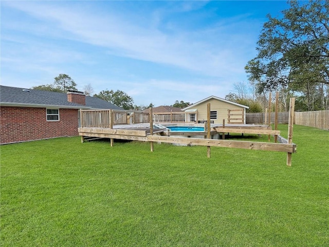 view of yard featuring a fenced in pool, a fenced backyard, and a deck