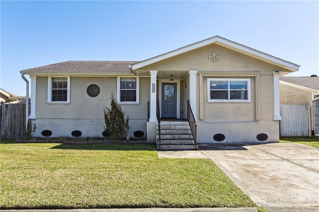 view of front facade featuring a front yard, fence, and stucco siding