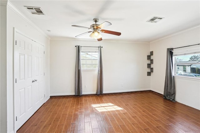 3244 Continental Dr, Kenner, LA 70065 - empty room with a ceiling fan, visible vents, crown molding, and wood finished floors