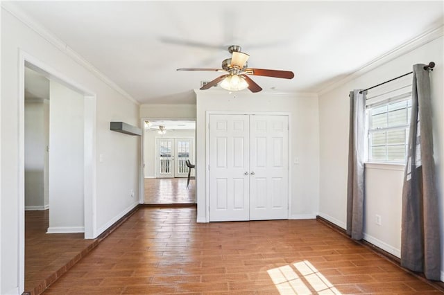 3244 Continental Dr, Kenner, LA 70065 - unfurnished bedroom featuring a ceiling fan, crown molding, baseboards, and wood finished floors