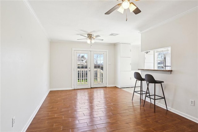 3244 Continental Dr, Kenner, LA 70065 - interior space featuring a ceiling fan, crown molding, baseboards, and dark wood-type flooring