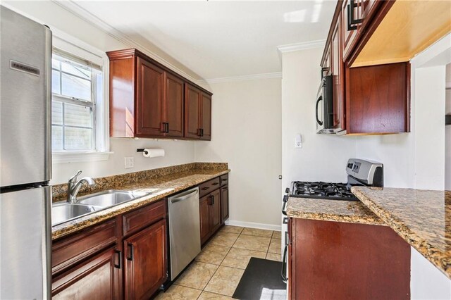 3244 Continental Dr, Kenner, LA 70065 - kitchen with light tile patterned floors, ornamental molding, dark stone countertops, stainless steel appliances, and a sink