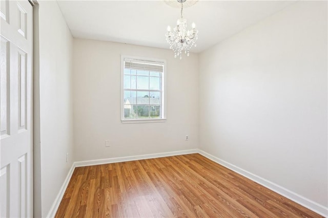 3244 Continental Dr, Kenner, LA 70065 - unfurnished room with a notable chandelier, baseboards, and wood finished floors
