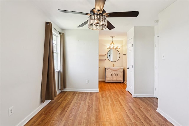 3244 Continental Dr, Kenner, LA 70065 - unfurnished bedroom with light wood-type flooring, connected bathroom, baseboards, and ceiling fan