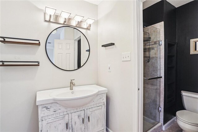 3244 Continental Dr, Kenner, LA 70065 - bathroom featuring a stall shower, baseboards, vanity, and toilet