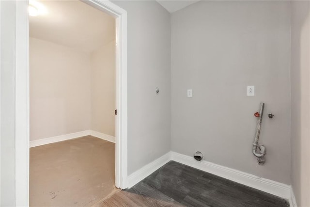 clothes washing area featuring washer hookup, laundry area, dark wood finished floors, and baseboards