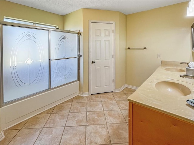 full bathroom featuring tile patterned floors, enclosed tub / shower combo, a sink, and double vanity