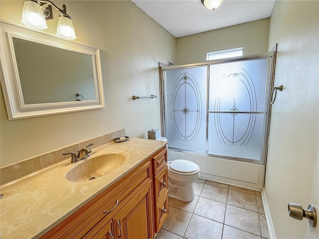 full bath with bath / shower combo with glass door, toilet, a textured ceiling, vanity, and tile patterned flooring