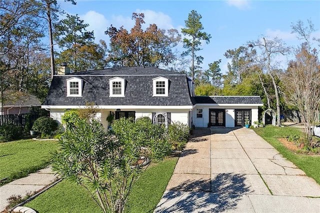 view of front of home featuring driveway, a shingled roof, a chimney, an attached carport, and a front yard