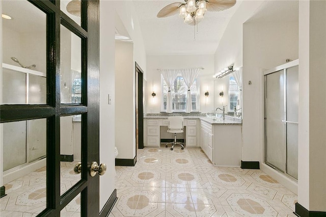 bathroom with tile patterned flooring, ceiling fan, vanity, and a shower stall