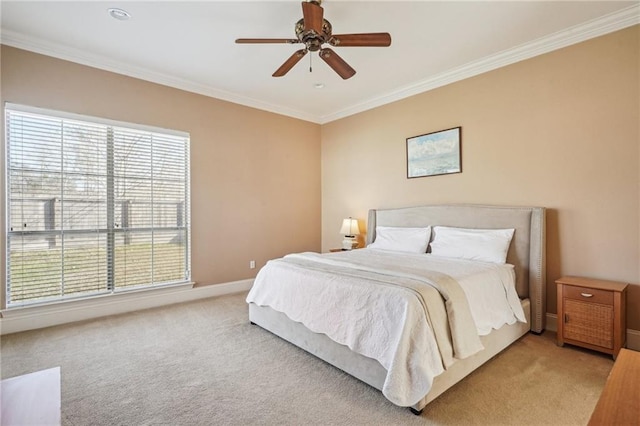 bedroom featuring light colored carpet, crown molding, baseboards, and ceiling fan