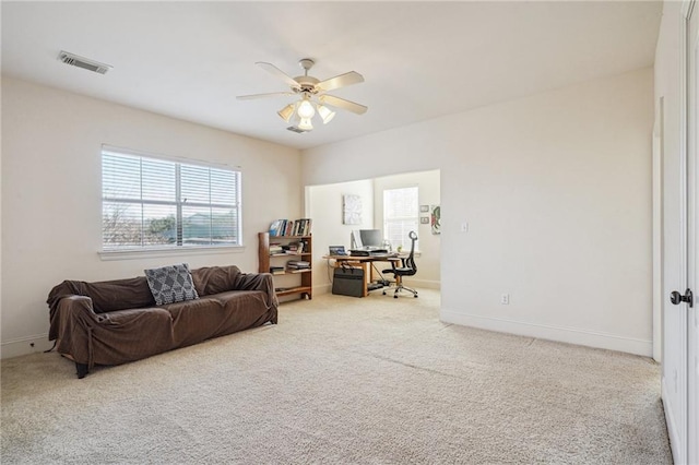 carpeted office featuring a ceiling fan, visible vents, and baseboards