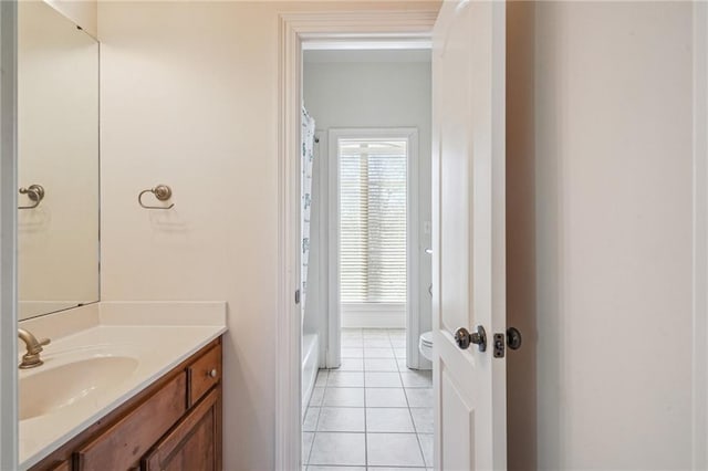 bathroom featuring tile patterned flooring, vanity, and toilet