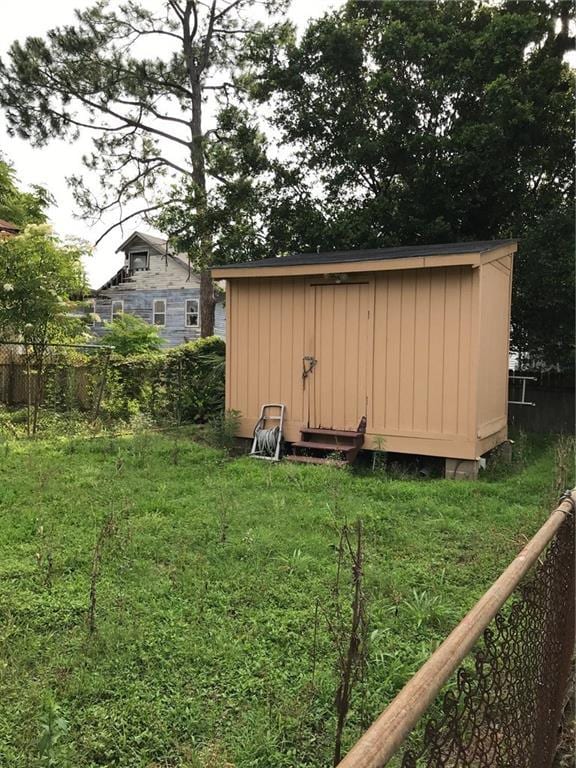 view of shed with fence