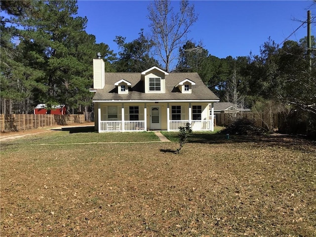 cape cod home featuring a chimney, fence, a porch, and a front yard