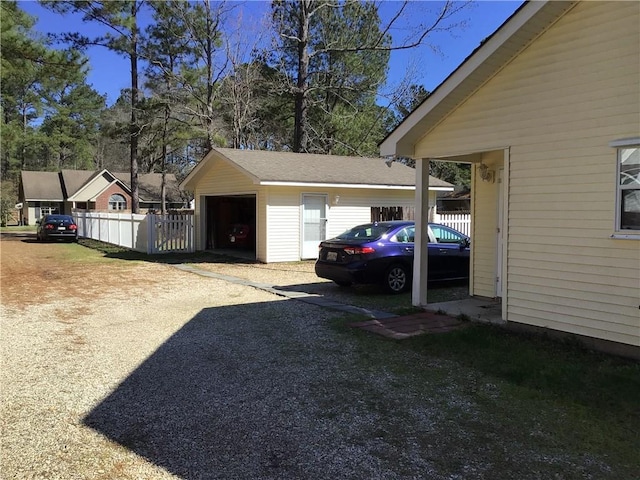 detached garage featuring fence