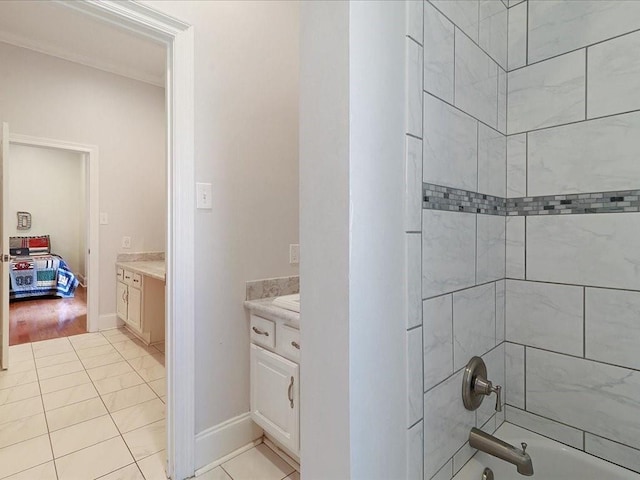 bathroom featuring washtub / shower combination, baseboards, vanity, and tile patterned floors