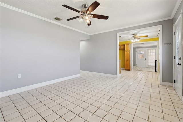 unfurnished room featuring crown molding, baseboards, and light tile patterned floors