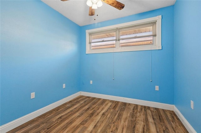 empty room with a ceiling fan, baseboards, and wood finished floors