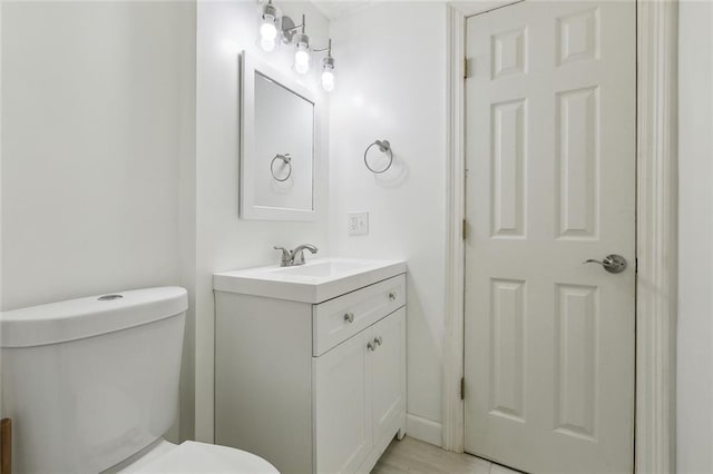 half bath featuring toilet and vanity