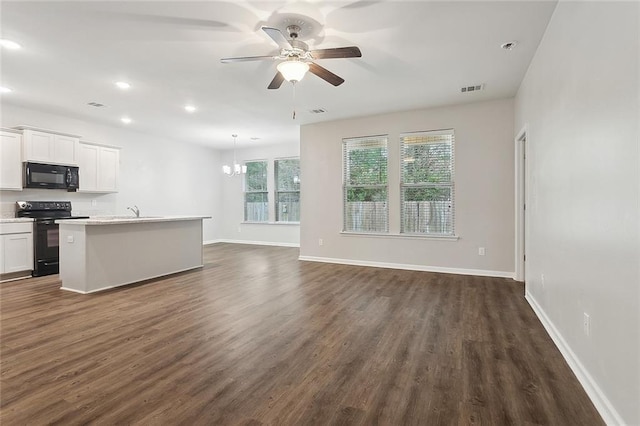 kitchen featuring a kitchen island with sink, white cabinets, open floor plan, light countertops, and black appliances