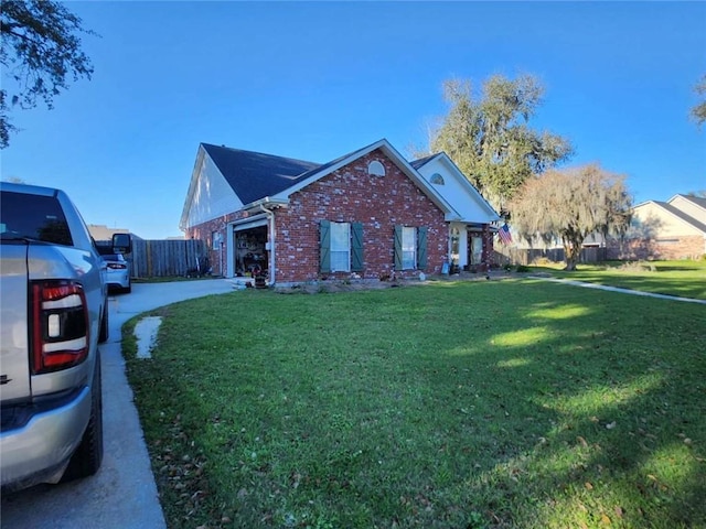 view of front facade with a garage, driveway, a front lawn, and brick siding