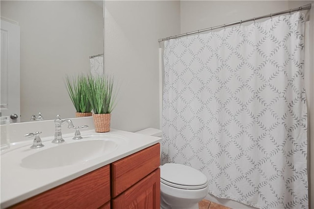 bathroom featuring a shower with curtain, vanity, toilet, and tile patterned floors