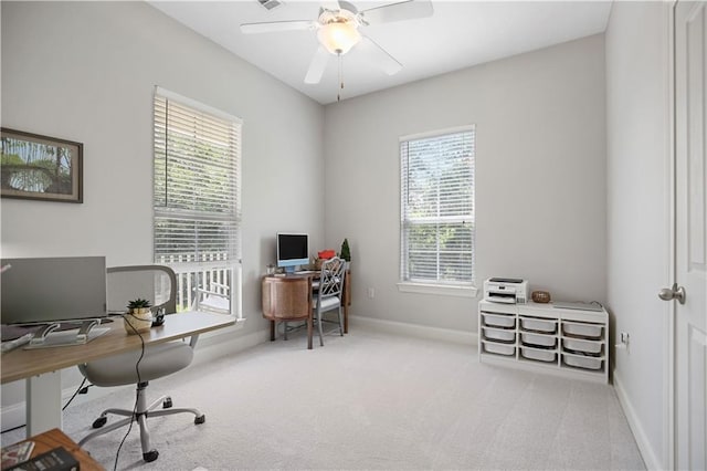 carpeted office space featuring a ceiling fan, visible vents, and baseboards