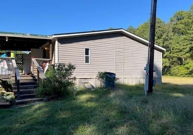 view of side of home featuring a yard