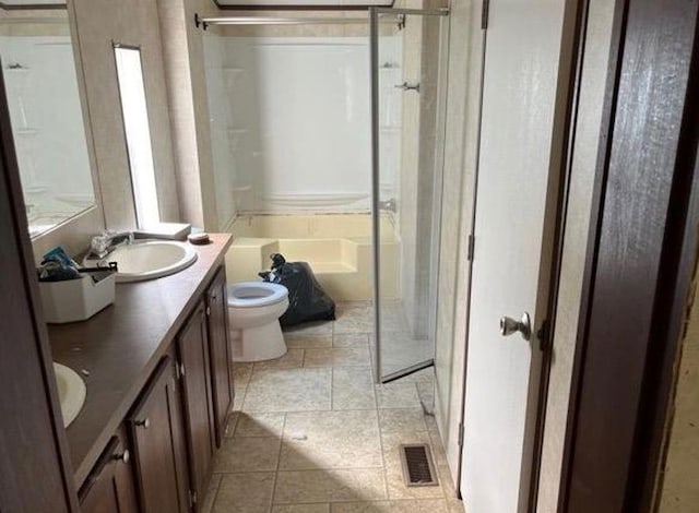 full bath with double vanity, visible vents, toilet, tile patterned flooring, and a sink