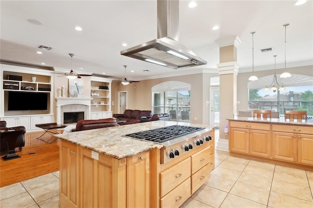 kitchen featuring crown molding, stainless steel gas stovetop, ceiling fan, light brown cabinets, and light tile patterned floors