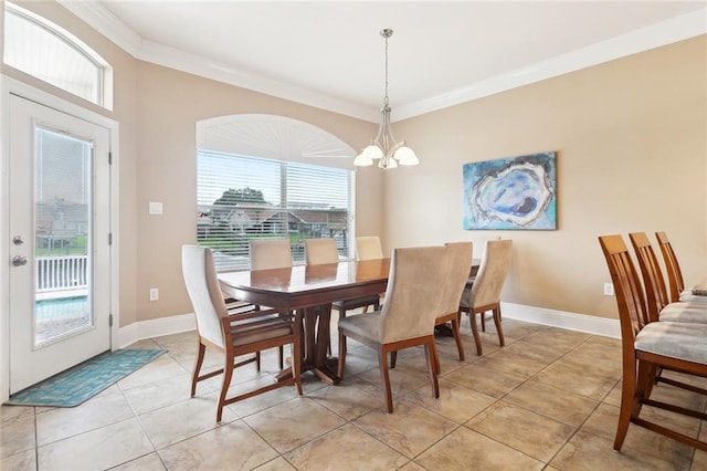 dining space with crown molding, healthy amount of natural light, a chandelier, light tile patterned floors, and baseboards