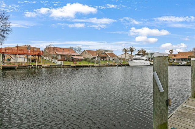 view of dock featuring a water view and a residential view