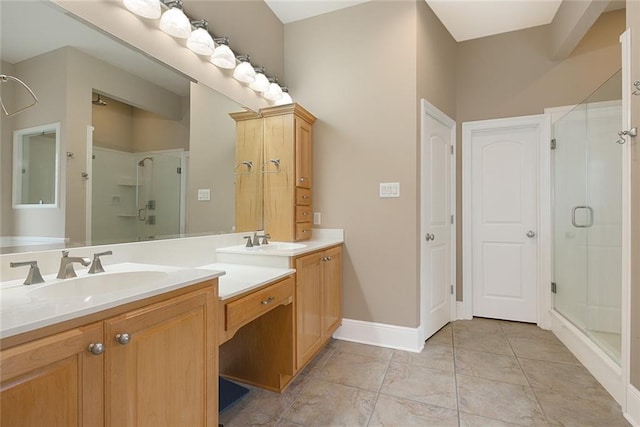 bathroom with a stall shower, vanity, and baseboards