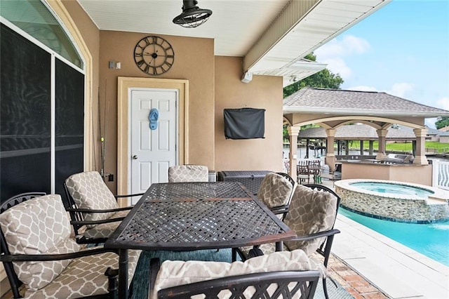 view of patio featuring outdoor dining area, an in-ground hot tub, a gazebo, an outdoor pool, and an outdoor kitchen