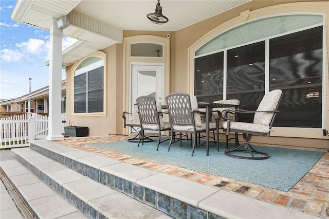 view of patio / terrace featuring fence, a gate, and outdoor dining area