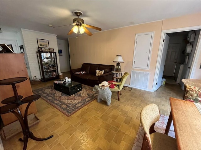 living room featuring ceiling fan and visible vents