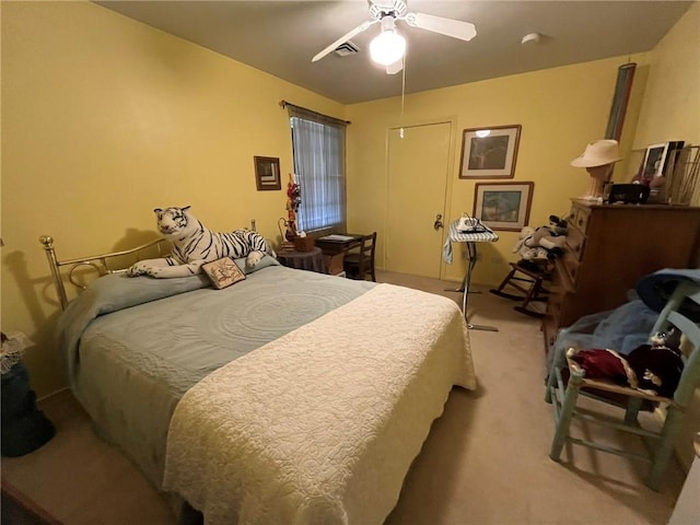 bedroom with light carpet, ceiling fan, and visible vents