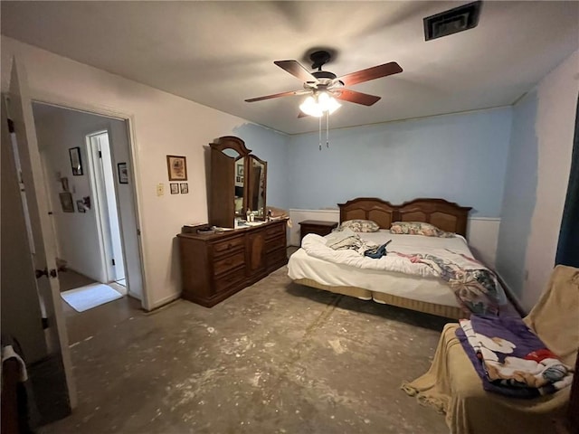 bedroom featuring concrete floors, visible vents, and a ceiling fan