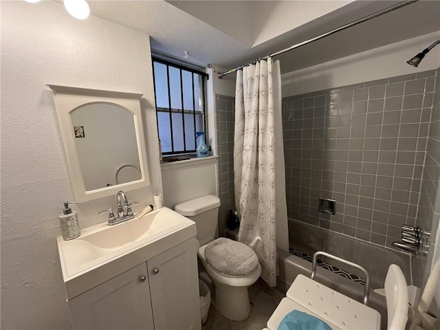 full bath with shower / bath combination with curtain, a textured wall, vanity, and toilet