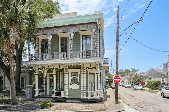 view of front of home with a porch and a balcony