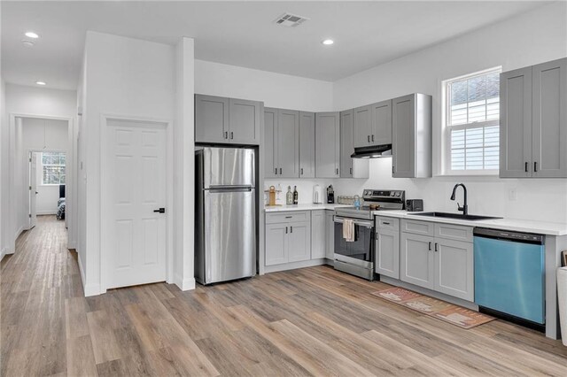 237274 Industry St, New Orleans, LA 70122 - kitchen with visible vents, stainless steel appliances, light countertops, under cabinet range hood, and a sink
