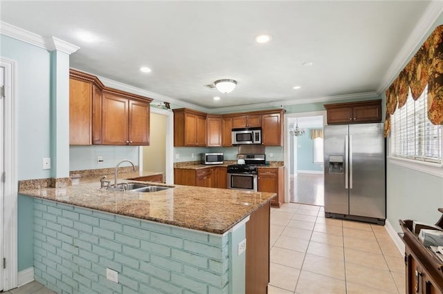 4929 Kawanee Ave, Metairie, LA 70006 - kitchen featuring appliances with stainless steel finishes, a sink, stone counters, brown cabinetry, and crown molding