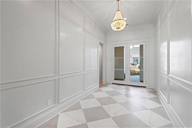 4221 Cypress Point Dr, Covington, LA 70433 - entryway featuring crown molding, a notable chandelier, french doors, and a decorative wall