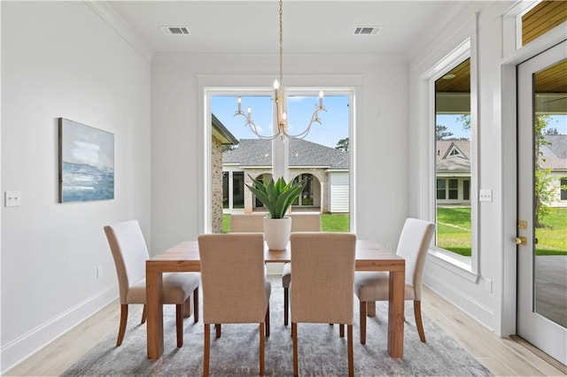4221 Cypress Point Dr, Covington, LA 70433 - dining space featuring visible vents, baseboards, a notable chandelier, light wood-style flooring, and a wealth of natural light