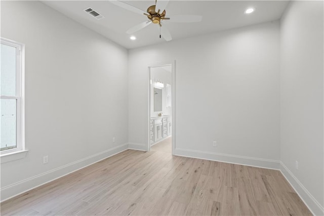 empty room with light wood finished floors, baseboards, visible vents, and recessed lighting