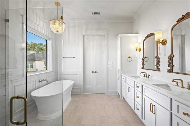 4221 Cypress Point Dr, Covington, LA 70433 - full bath with a sink, double vanity, a chandelier, and a freestanding bath