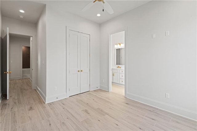 unfurnished bedroom featuring baseboards, a closet, recessed lighting, and light wood-style floors